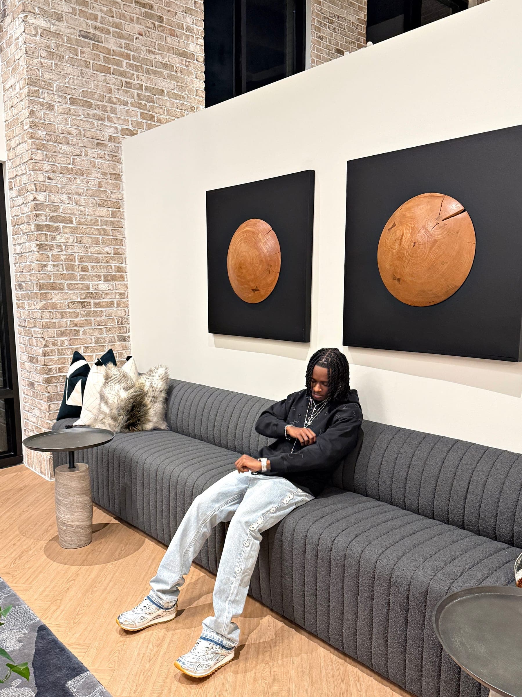 Strange Loots streetwear — lookbook shot on a black sofa